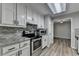 Updated kitchen features stainless steel appliances, granite countertops, and white cabinets at 425 Charlyne Way, Dacula, GA 30019