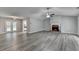 An expansive living room with a brick fireplace, wood-look flooring, and ample natural light at 425 Charlyne Way, Dacula, GA 30019