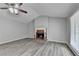 Bright living room featuring hardwood floors, a brick fireplace and neutral paint at 425 Charlyne Way, Dacula, GA 30019