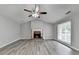 Bright living room featuring hardwood floors, a brick fireplace and neutral paint at 425 Charlyne Way, Dacula, GA 30019