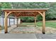 Backyard covered patio with wood frame and stone tile flooring sits next to a shed at 425 Charlyne Way, Dacula, GA 30019