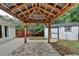 Backyard covered patio with stone flooring near white shed and wooden fence at 425 Charlyne Way, Dacula, GA 30019
