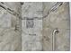 Close up of a renovated tile shower with modern fixtures and convenient grab bars at 425 Charlyne Way, Dacula, GA 30019