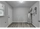 Utility room with updated flooring, window, and modern water heater at 425 Charlyne Way, Dacula, GA 30019