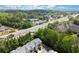 Aerial view of townhomes near a bustling street, surrounded by lush trees at 5686 Lawley Dr, Alpharetta, GA 30022