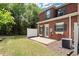 Brick townhouse with a cozy patio, white fence, and small well-maintained yard at 5686 Lawley Dr, Alpharetta, GA 30022