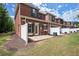 Brick townhouse with a cozy patio, white fence, and small well-maintained yard at 5686 Lawley Dr, Alpharetta, GA 30022