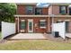 Brick townhouse with a cozy patio, white fence, and small well-maintained yard at 5686 Lawley Dr, Alpharetta, GA 30022