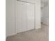 Bedroom featuring a closet with paneled bifold doors and light-colored carpet at 5686 Lawley Dr, Alpharetta, GA 30022