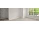 Cozy bedroom featuring neutral carpet, ample lighting, and a door at 5686 Lawley Dr, Alpharetta, GA 30022