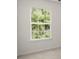 Bedroom featuring a window with blinds overlooking trees and light-colored carpet at 5686 Lawley Dr, Alpharetta, GA 30022