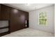 Bedroom featuring built-in shelving with cupboards, and a window with blinds at 5686 Lawley Dr, Alpharetta, GA 30022