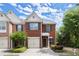 Charming brick townhome with a one-car garage, manicured lawn, and mature landscaping at 5686 Lawley Dr, Alpharetta, GA 30022
