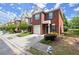 Charming brick townhome featuring a single-car garage, manicured landscaping, and a welcoming entrance at 5686 Lawley Dr, Alpharetta, GA 30022