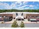 Inviting Regal movie theater exterior with a modern design and multiple storefronts under a sunny sky at 5686 Lawley Dr, Alpharetta, GA 30022