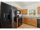 Modern kitchen with a black refrigerator and updated appliances at 5686 Lawley Dr, Alpharetta, GA 30022