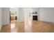 Open-concept living room with hardwood floors, fireplace, and views into the kitchen at 5686 Lawley Dr, Alpharetta, GA 30022
