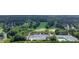 Lush community golf course view in aerial shot, surrounded by green trees and a pond at 6034 Addington Nw Dr, Acworth, GA 30101