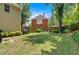Fenced backyard with a large, green lawn, featuring landscaping and a garden at 6034 Addington Nw Dr, Acworth, GA 30101