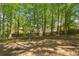 Tranquil backyard with mature trees and natural landscaping, offering a private and peaceful outdoor retreat at 6034 Addington Nw Dr, Acworth, GA 30101