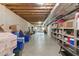 Unfinished basement with storage shelves and visible ceiling pipes at 6034 Addington Nw Dr, Acworth, GA 30101