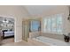 Bright bathroom with a soaking tub and a separate glass door shower at 6034 Addington Nw Dr, Acworth, GA 30101