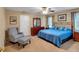 Comfortable bedroom featuring a ceiling fan, soft lighting and a cozy sitting area at 6034 Addington Nw Dr, Acworth, GA 30101