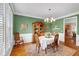 Formal dining area with hardwood floors, area rug, and decorative chandelier at 6034 Addington Nw Dr, Acworth, GA 30101