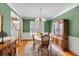 Traditional dining room featuring wooden floors, china cabinet, and decorative chandelier at 6034 Addington Nw Dr, Acworth, GA 30101