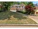 Classic brick home featuring manicured landscaping and mature trees, offering great curb appeal at 6034 Addington Nw Dr, Acworth, GA 30101