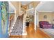 Welcoming foyer with a grand staircase, hardwood floors, and elegant decor at 6034 Addington Nw Dr, Acworth, GA 30101