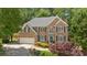Classic brick home featuring a well-maintained lawn, a two-car garage, and attractive curb appeal at 6034 Addington Nw Dr, Acworth, GA 30101