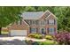Charming two-story brick home with well-manicured landscaping, a two-car garage, and a welcoming front entrance at 6034 Addington Nw Dr, Acworth, GA 30101