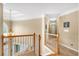 Upstairs hallway with wooden banister and stairs at 6034 Addington Nw Dr, Acworth, GA 30101