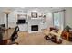 Home office with custom built-ins, a fireplace, and a comfortable seating area at 6034 Addington Nw Dr, Acworth, GA 30101