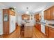 Functional kitchen with wood cabinets, a breakfast bar, hardwood floors, and stainless appliances at 6034 Addington Nw Dr, Acworth, GA 30101