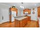 Bright kitchen with a center island, wood cabinets, and white appliances at 6034 Addington Nw Dr, Acworth, GA 30101