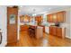 Well-lit kitchen with warm wood cabinetry, bar-style seating, and hardwood flooring at 6034 Addington Nw Dr, Acworth, GA 30101