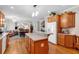 Open concept kitchen with an island, wooden cabinets, and a view of the living and dining areas at 6034 Addington Nw Dr, Acworth, GA 30101