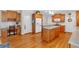 Well-lit kitchen featuring wood floors, matching cabinetry, an island, and modern appliances at 6034 Addington Nw Dr, Acworth, GA 30101
