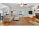 Open living area with hardwood floors, a fireplace, built-in shelving, and access to the outdoor patio at 6034 Addington Nw Dr, Acworth, GA 30101