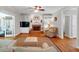 Cozy living room with brick fireplace, built-in shelving, hardwood floors and neutral decor at 6034 Addington Nw Dr, Acworth, GA 30101