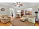 Comfortable living room featuring hardwood floors and seamless transition into the kitchen area at 6034 Addington Nw Dr, Acworth, GA 30101