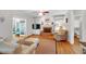 Bright living room with hardwood floors, a brick fireplace, built-in shelving and a comfortable seating area at 6034 Addington Nw Dr, Acworth, GA 30101