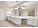 Spacious main bathroom featuring double sinks, a vanity area, and custom cabinets at 6034 Addington Nw Dr, Acworth, GA 30101