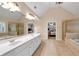Spacious main bathroom with double sinks, a large tub, and a separate glass shower at 6034 Addington Nw Dr, Acworth, GA 30101
