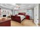 Spacious main bedroom boasts a tray ceiling, ceiling fan and a cozy fireplace at 6034 Addington Nw Dr, Acworth, GA 30101