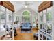 Bright sunroom with hardwood floors and large windows offering scenic backyard views at 6034 Addington Nw Dr, Acworth, GA 30101