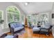 Charming sunroom with vaulted ceiling, large windows, wicker furniture and natural light at 6034 Addington Nw Dr, Acworth, GA 30101