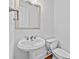 Half bathroom featuring a pedestal sink and toilet with white fixtures and neutral walls at 2260 Edgartown Se Ln # 1, Smyrna, GA 30080